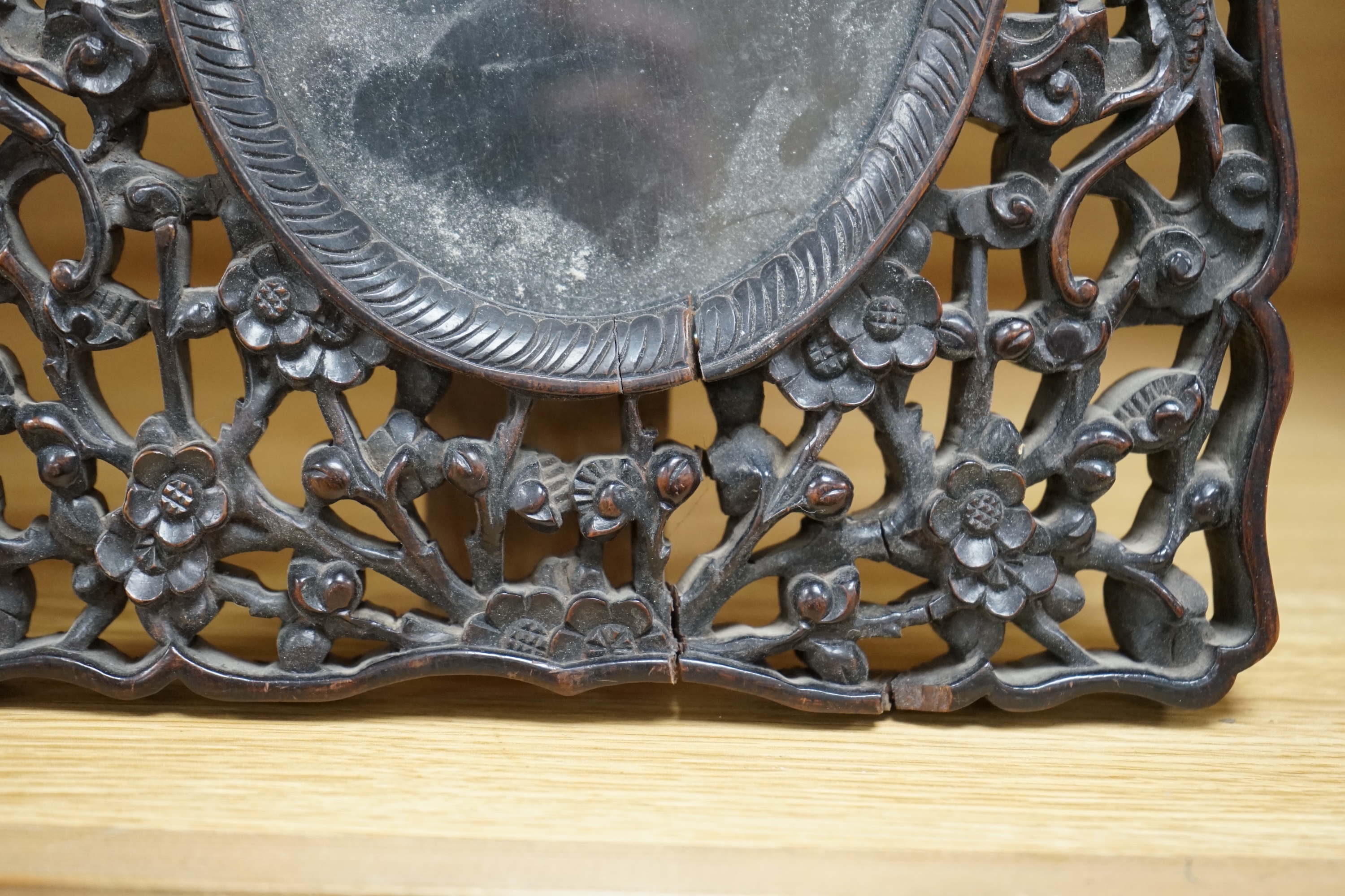 A Chinese carved hongmu ‘dragon’ photo frame, c.1900, 29cm high. Condition - cracked and chipped